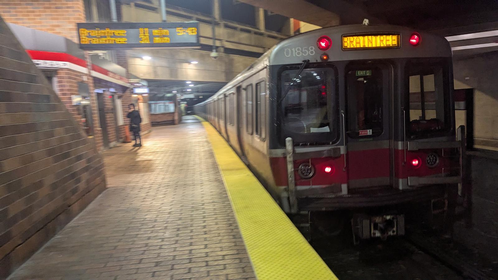 mbta red line service inbound to braintree departing from a station at night. the cars are part of the no.3 01800 fleet of rolling stock. the front unit pictured is 01858.